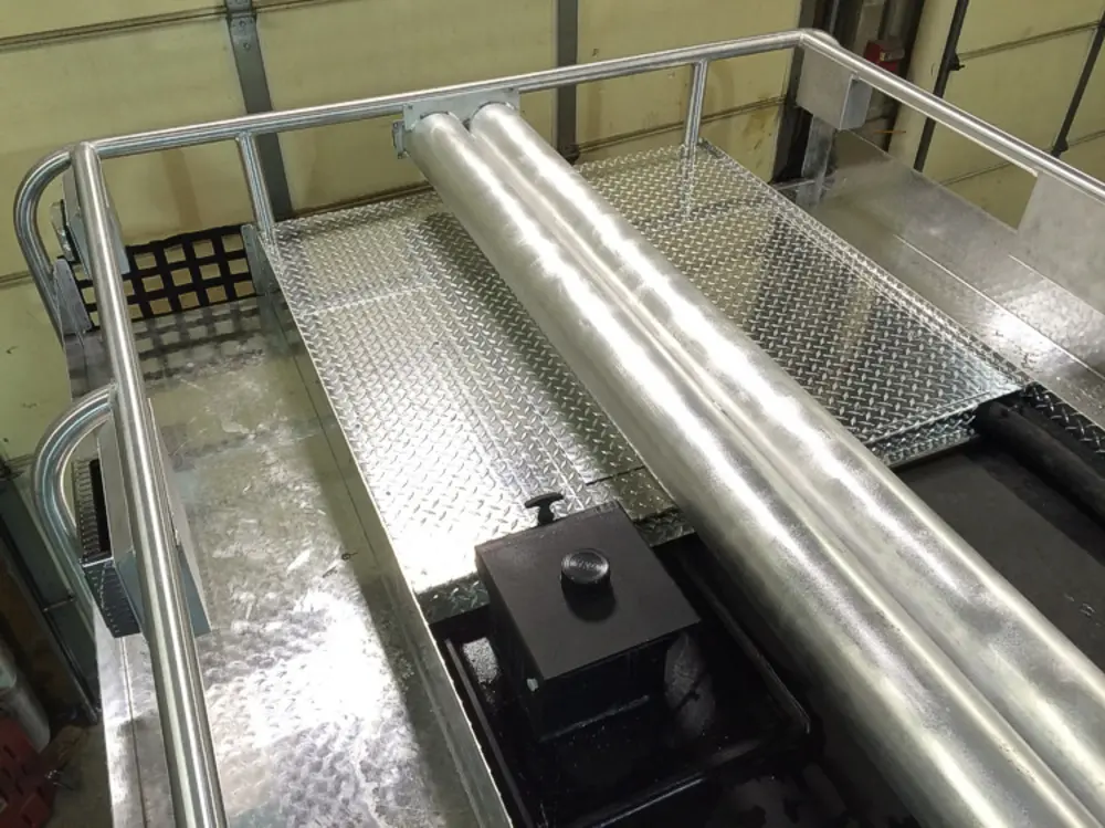 Exterior view of small fire truck showing cab, body compartments, and wheel/tire area.