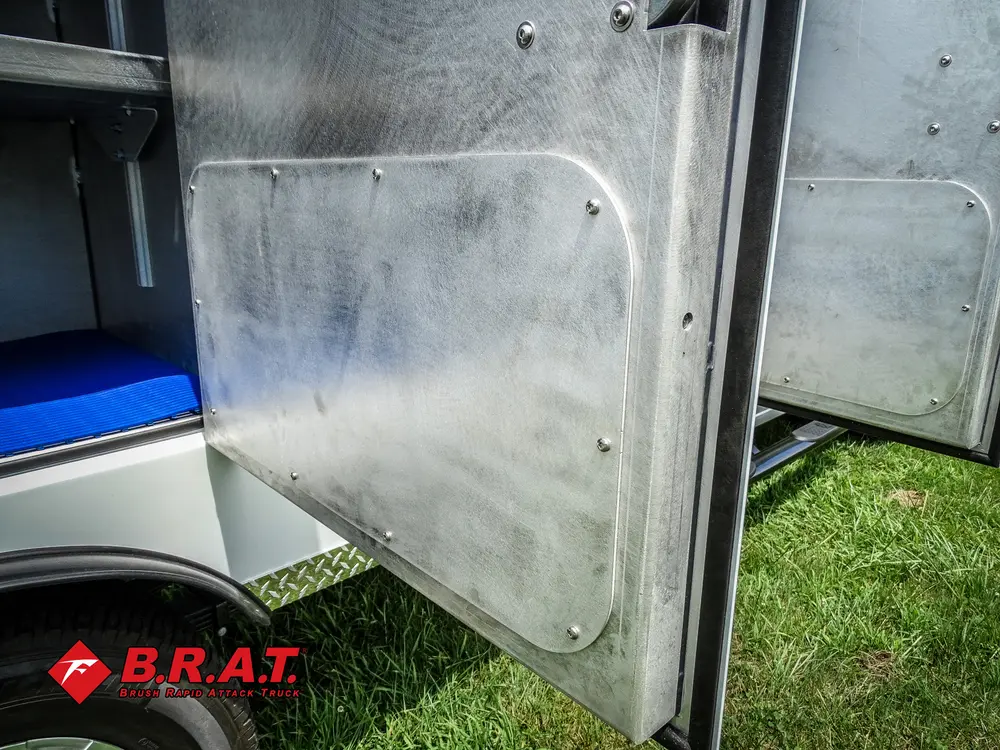 Open compartment door and stainless interior wall close-up.