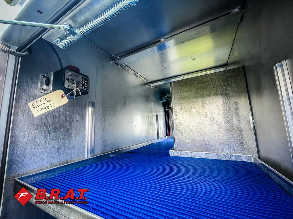 Long compartment interior with blue anti-slip floor.