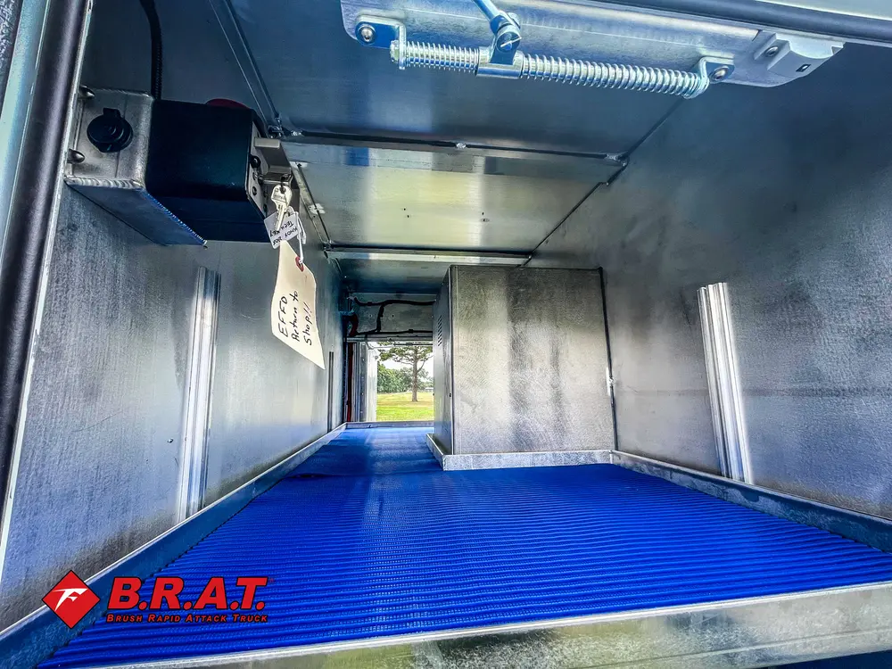 Wide stainless compartment bay with overhead lighting.