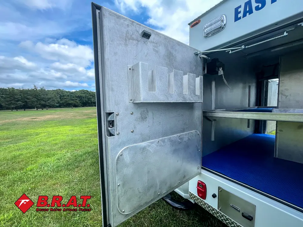 Open compartment door and shelf bay viewed from rear angle.