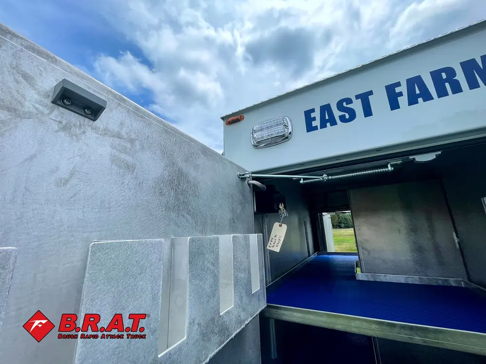 Outer side panel and open compartment door below lettering.