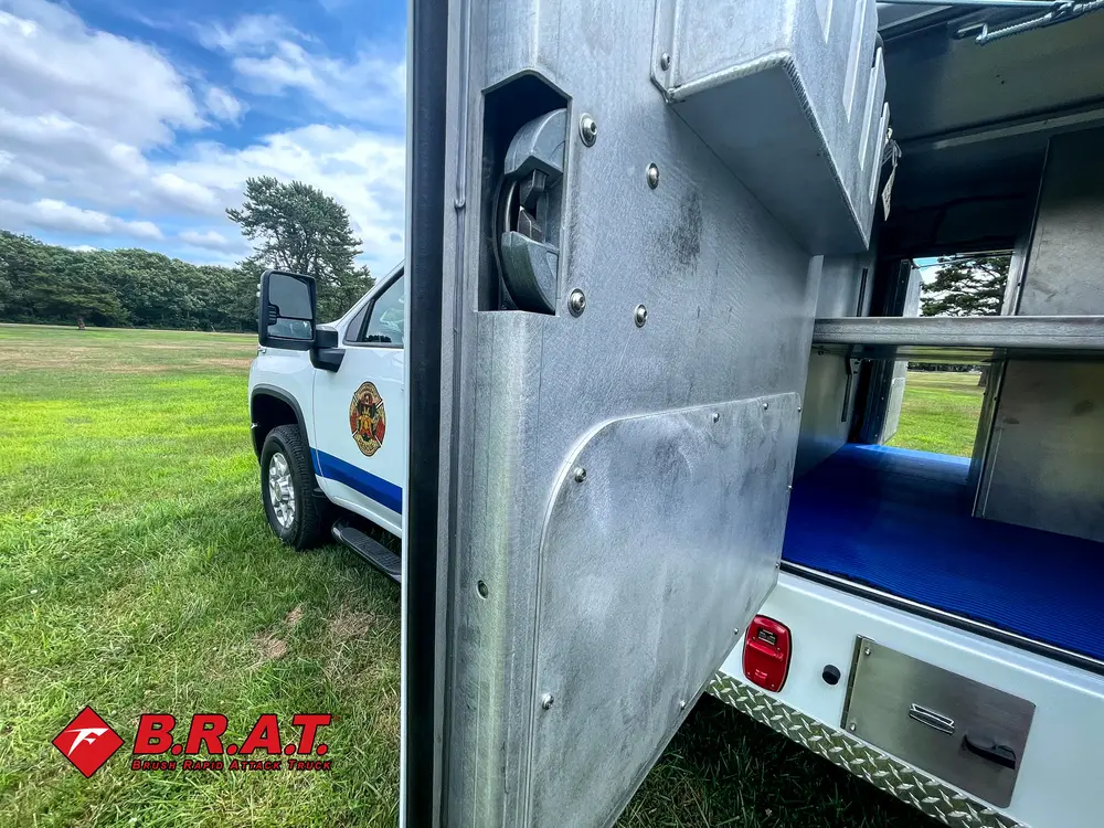 Compartment opening and side wall panel with latch hardware.