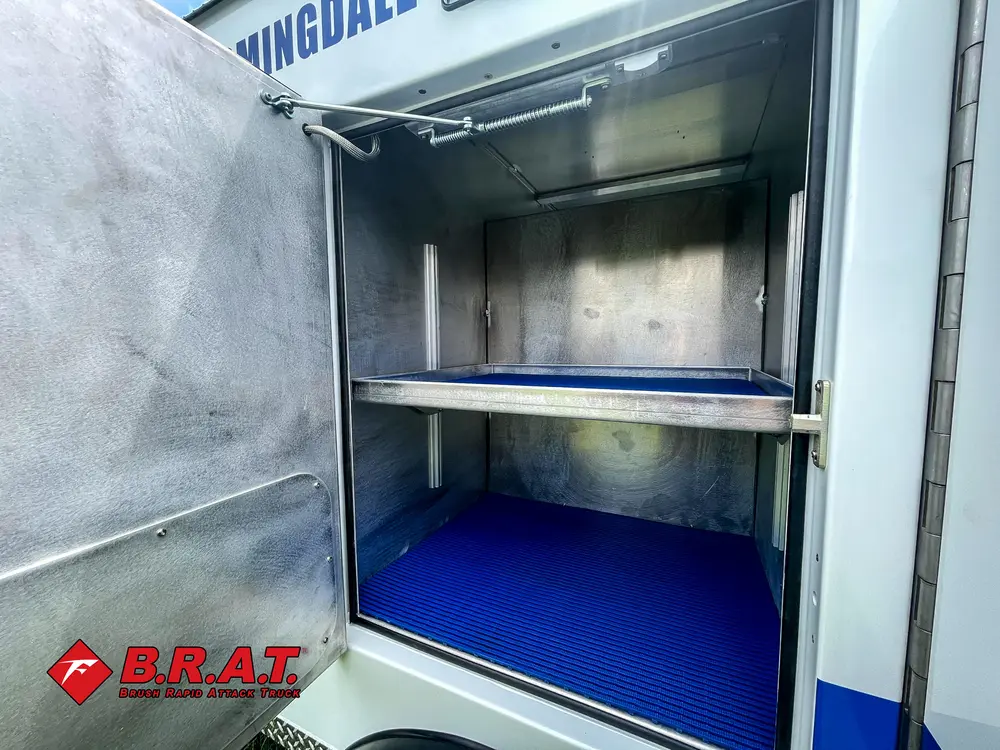 Open upper side compartment with shelf and interior lighting.