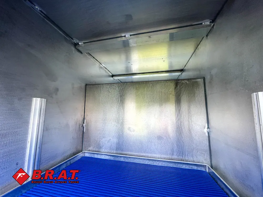 Stainless compartment interior with upper shelf and blue floor.
