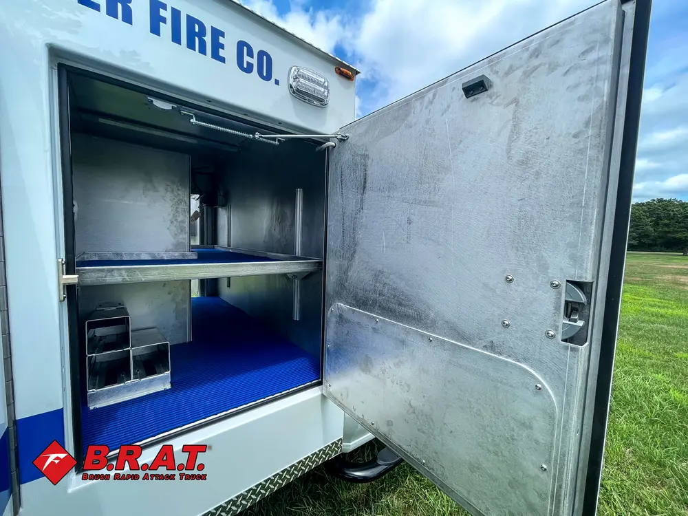 Open compartment under side lettering with shelf and floor tray.