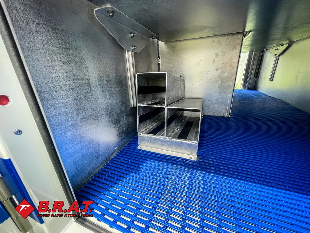 Rear interior cargo floor with blue diamond-pattern coating.