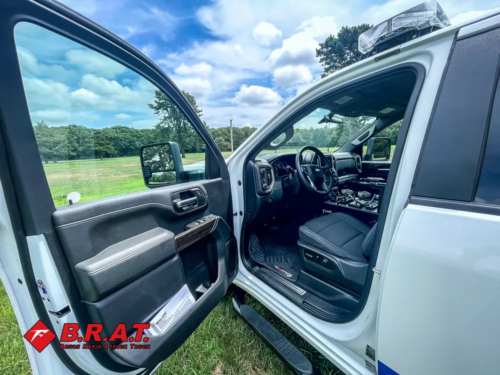Open driver door showing cab entry and dashboard.