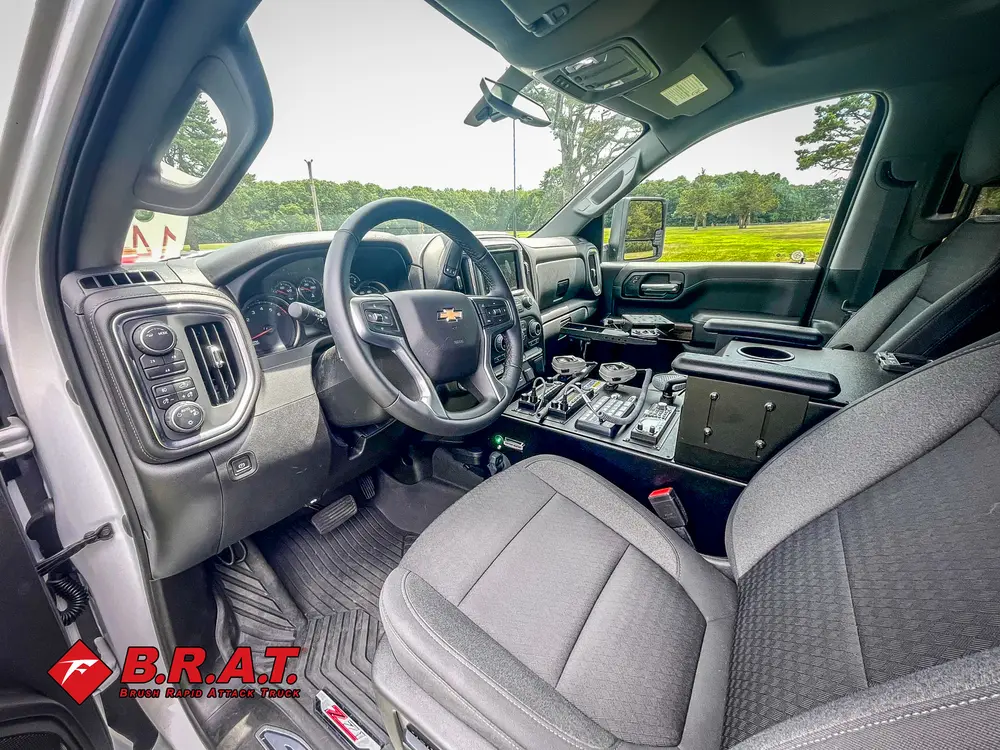 Driver cabin view with steering wheel and center console.