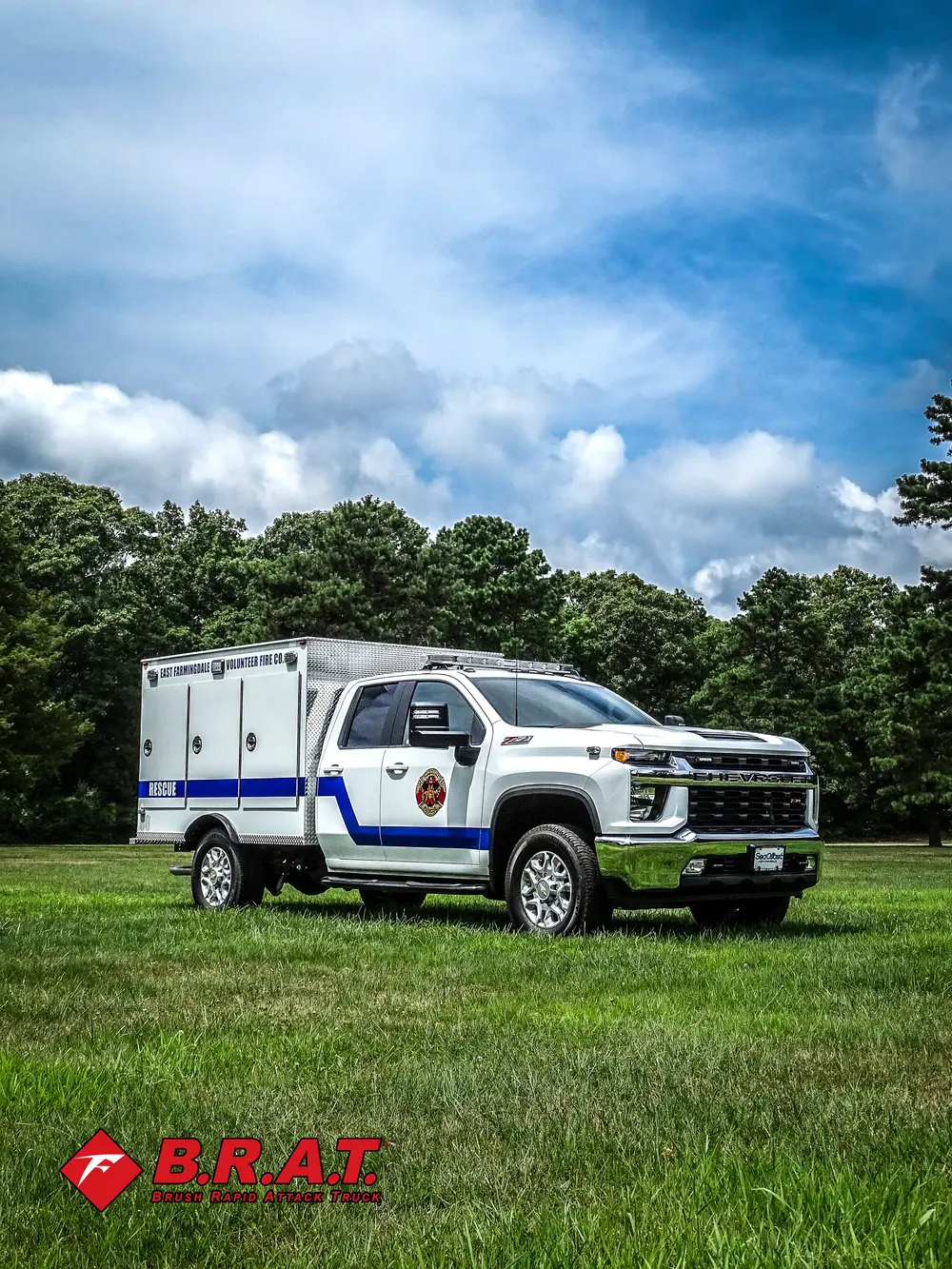 Driver-side three-quarter view of rescue truck on grass.