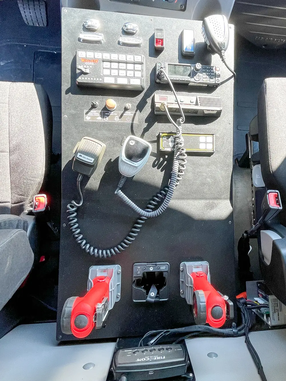 Center console with radio handset and toggle switches.