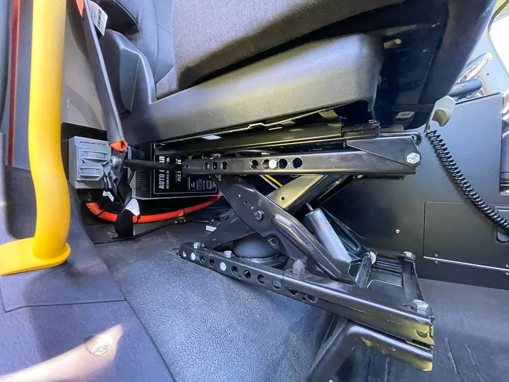 Under-seat equipment mount and wiring below front seat.