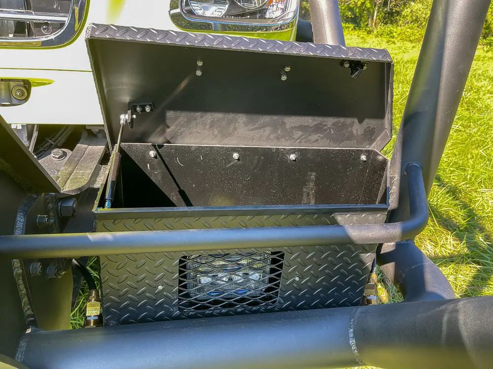 Open front bumper storage box beneath grille guard.