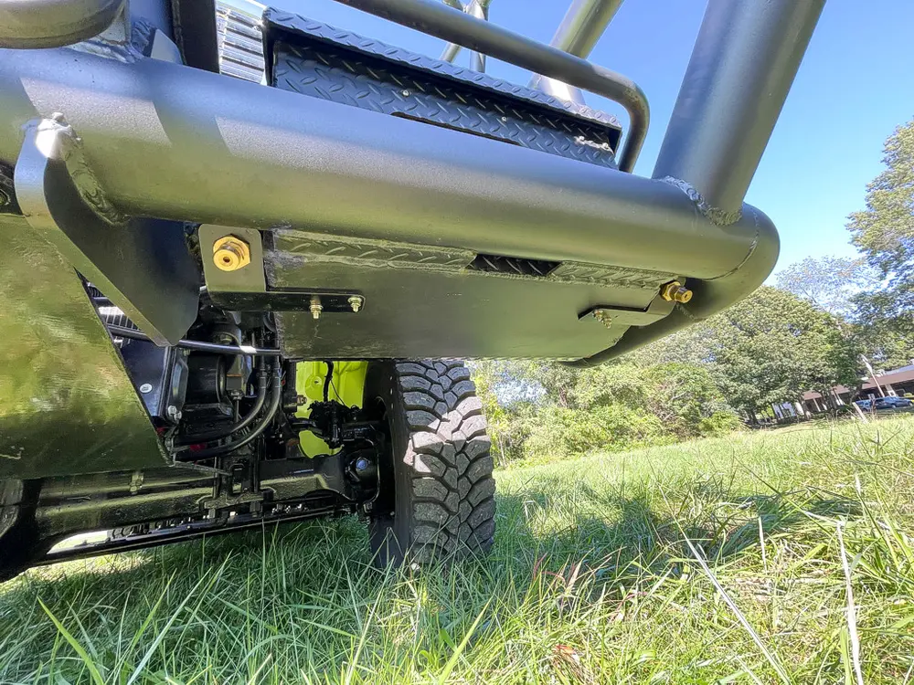 Low underside view of front brush guard and frame rails.