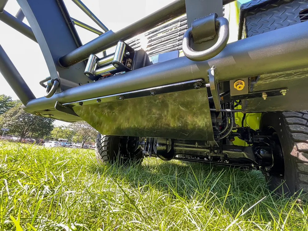 Underbody side view showing suspension and skid bars.