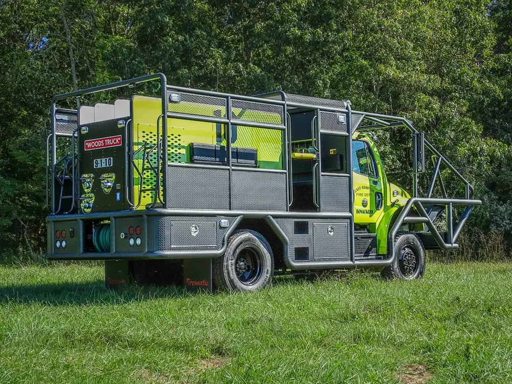 Rear driver-side angle showing side compartments and cage frame.