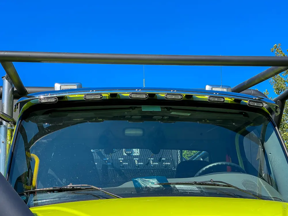 Roofline light bar seen above windshield and cage rails.