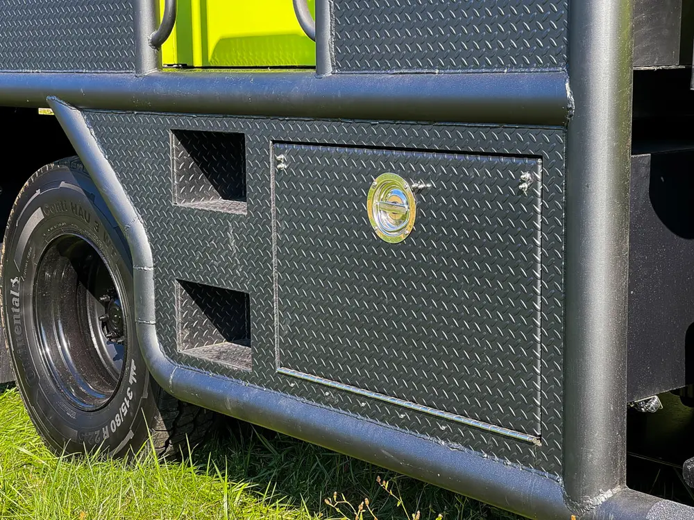 Closed side storage compartment doors with round latch knobs.