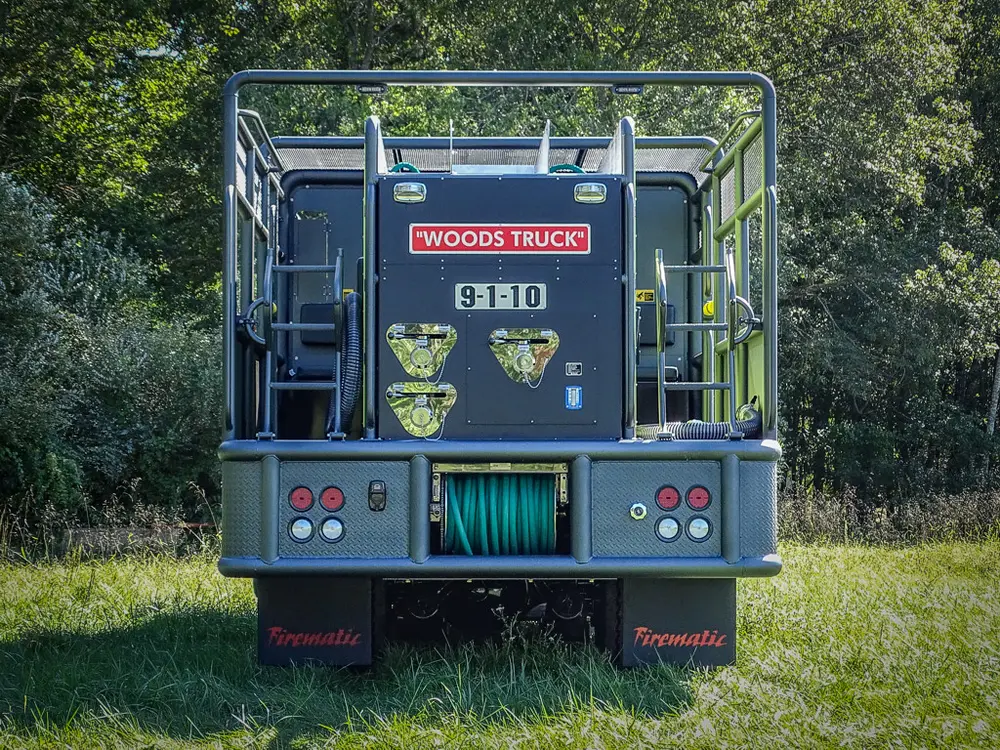Straight rear view with hose reel opening and rear step.