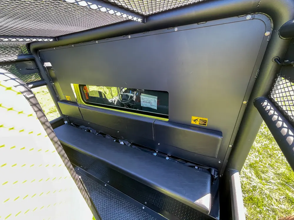 Open upper side compartment with narrow shelf and tools.