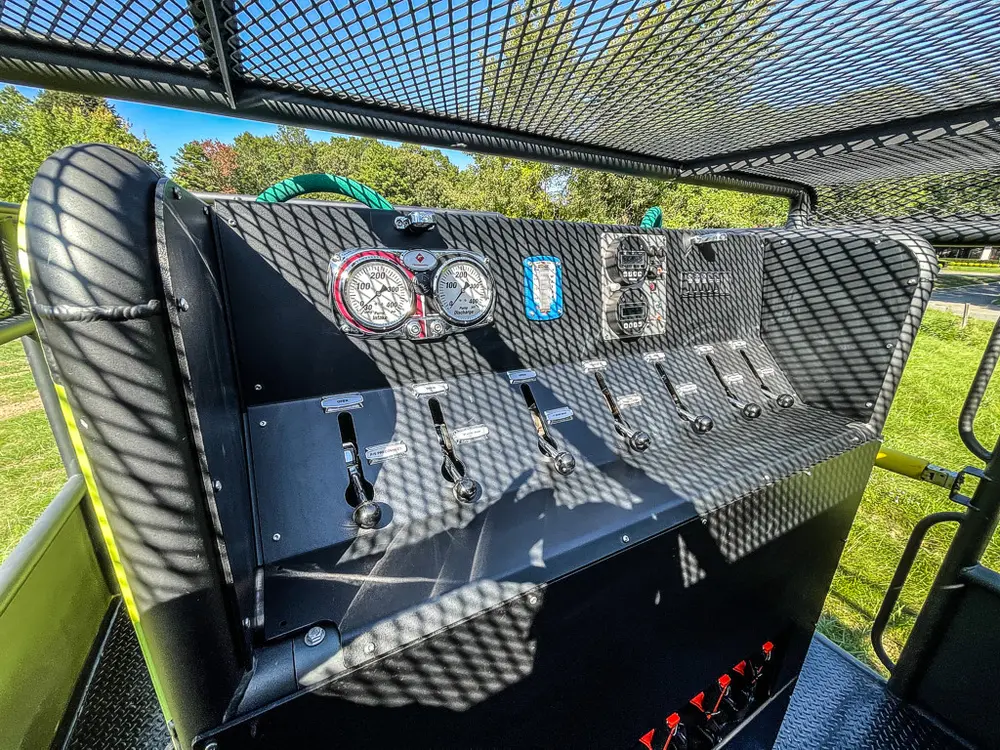 Rear pump control panel with gauges and lever controls.