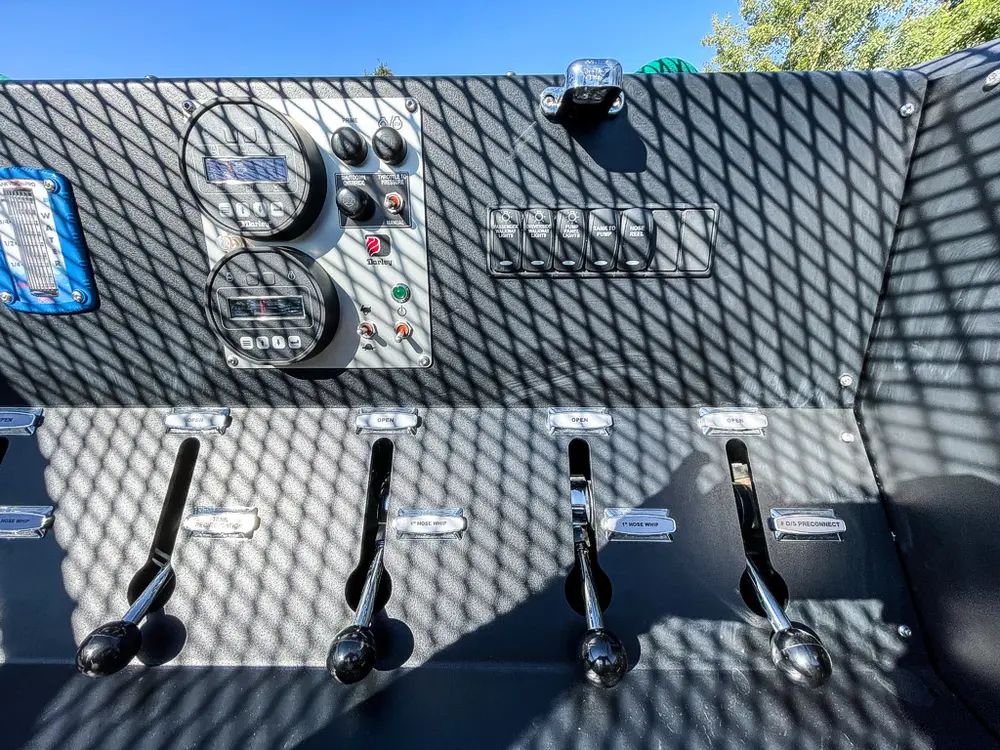Control levers and couplings on rear pump panel.