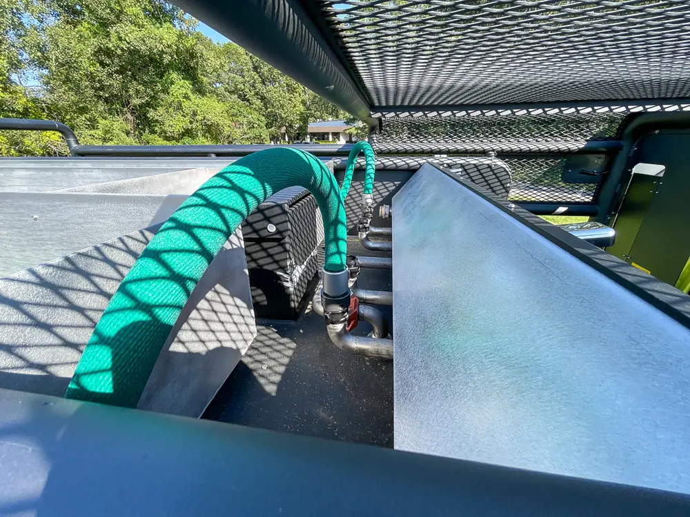 Rear deck angle with green hose loops and tank top.
