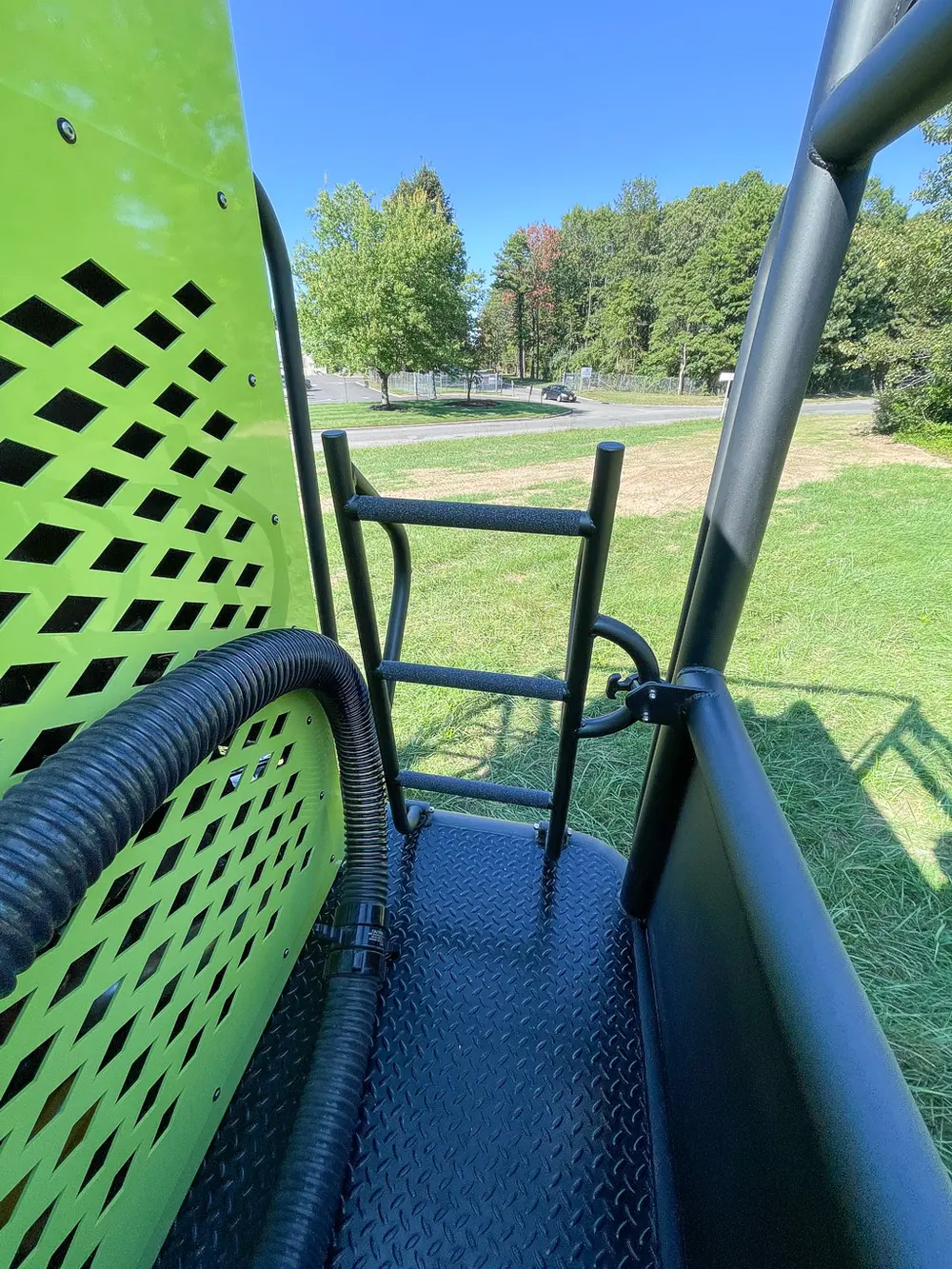 Rear corner walkway with perforated cage panel and ladder.
