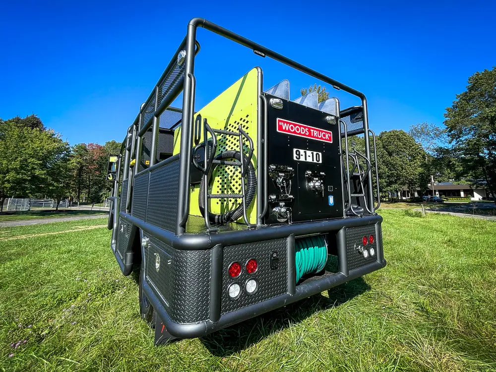 Rear corner close-up with taillights and lower compartment openings.