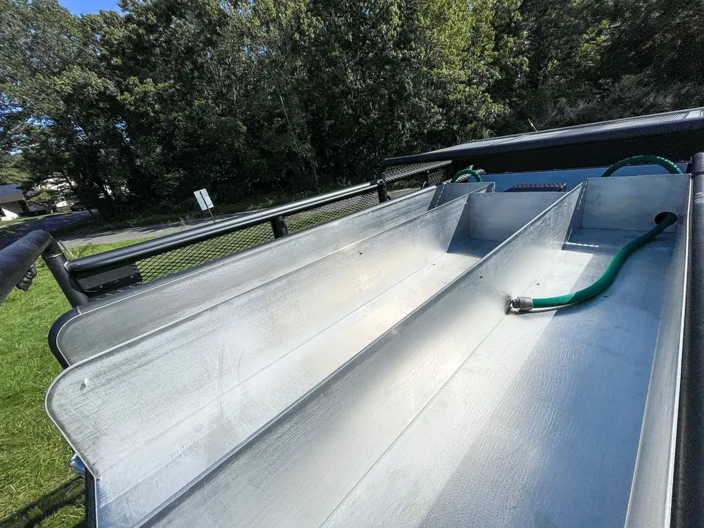 Top tank surface with metal fittings and straps.