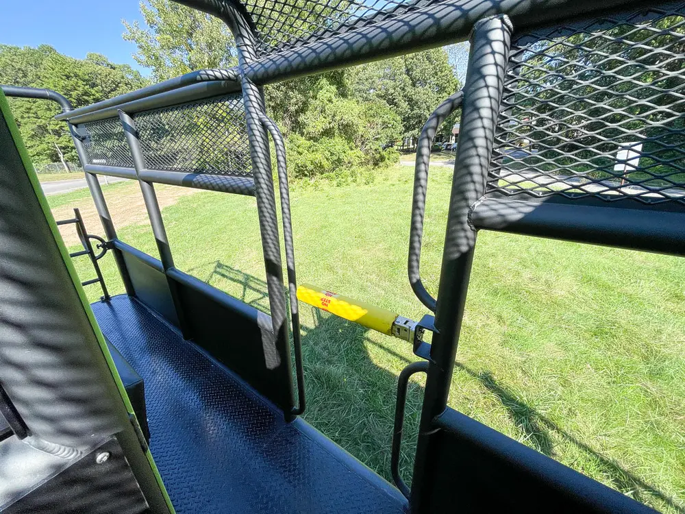 Rear side walkway with mesh rail and body panel.