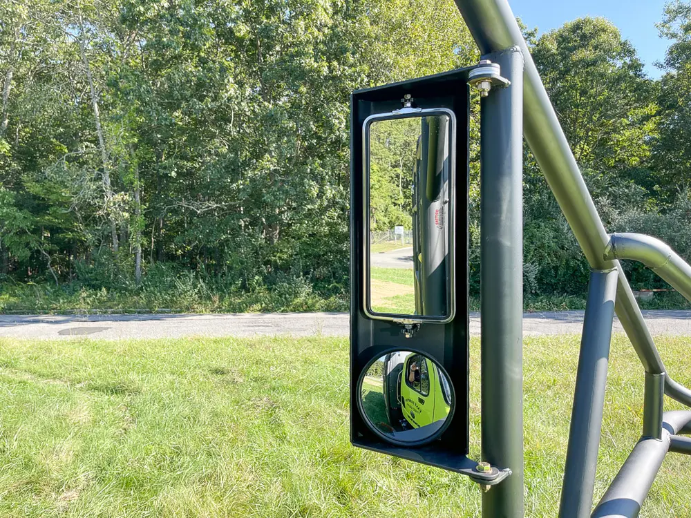 Large side mirror mounted on cage frame upright.