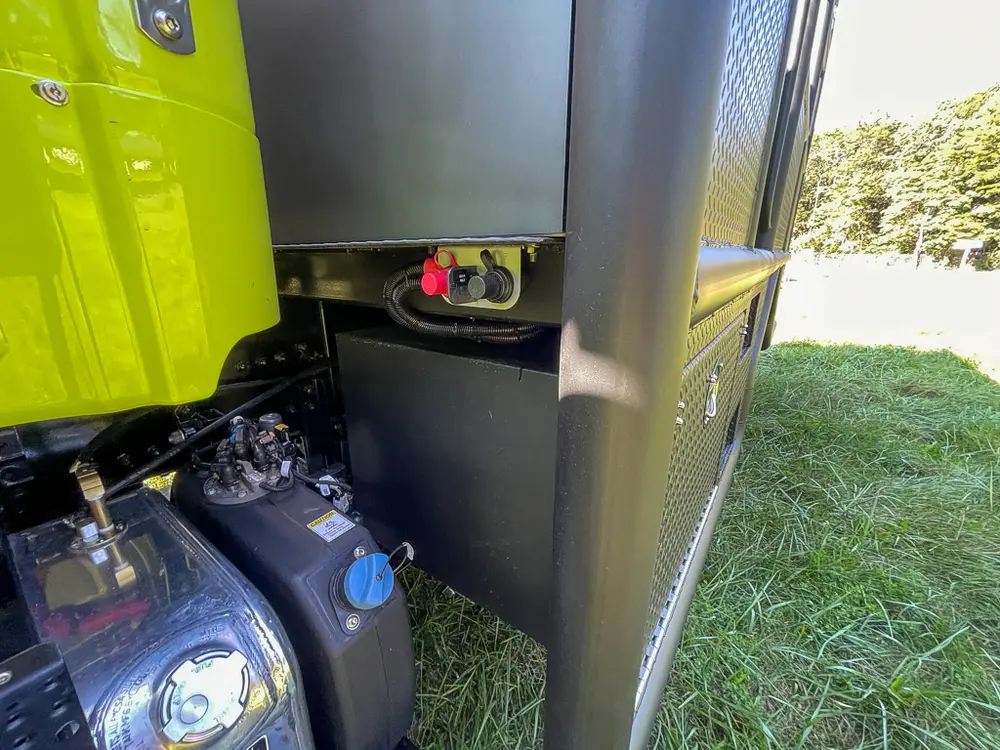 Pump plumbing and fittings behind open side panel.