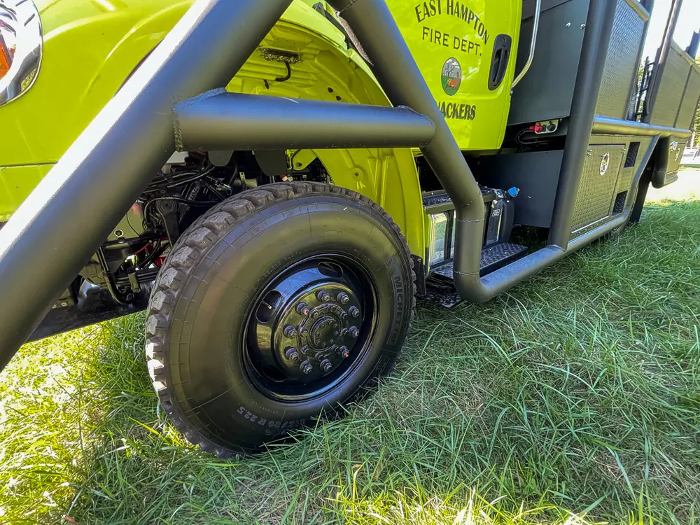 Passenger-side midsection with rugged rear wheel and step.