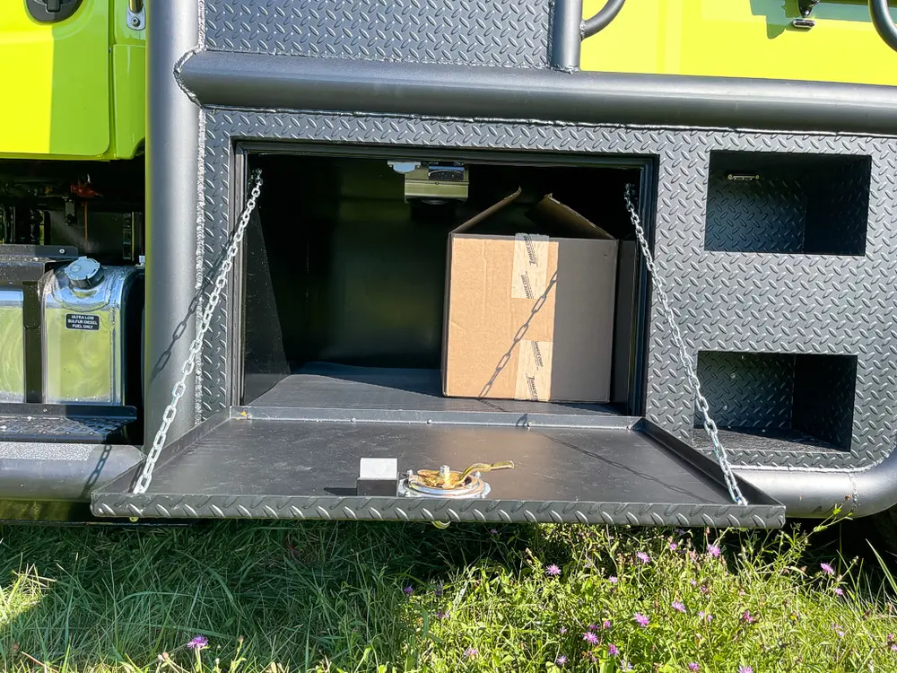 Open long lower compartment with cardboard box inside.