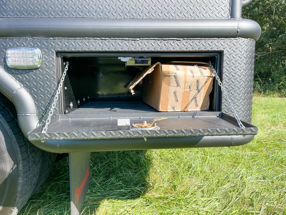 Open lower compartment with box and dark storage bay.