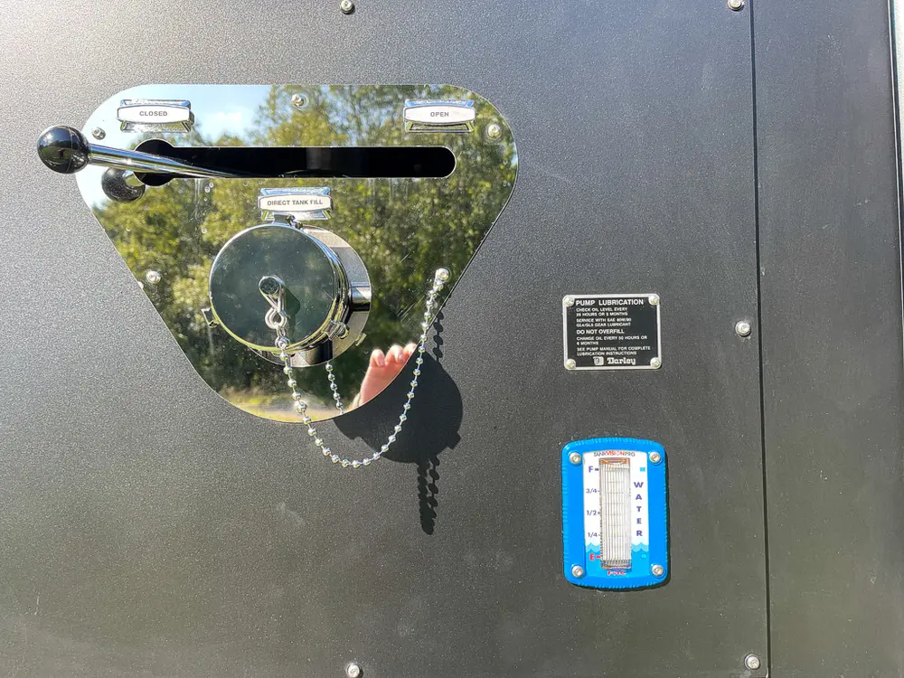 Single rear hose coupling outlet with warning label below.