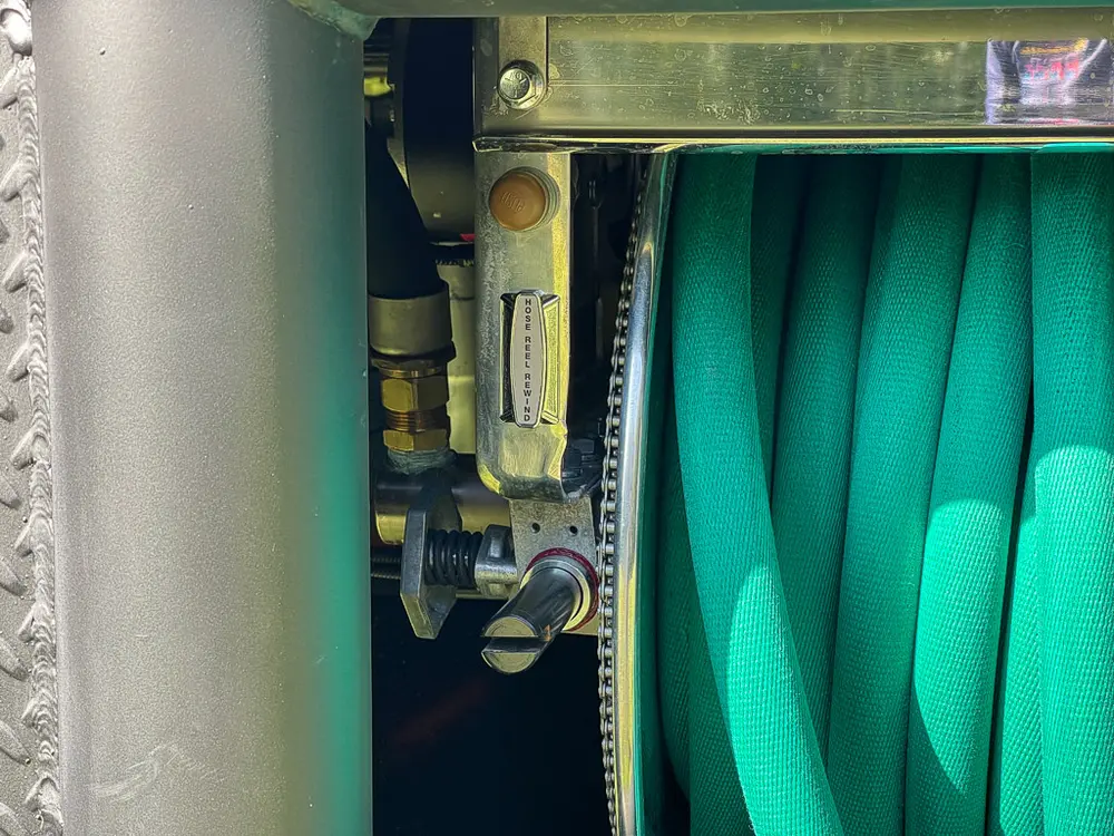 Side view of hose reel and pressure regulator hardware.