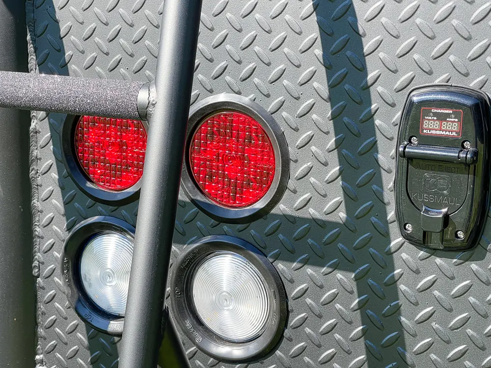 Rear corner light cluster with red and white lenses.