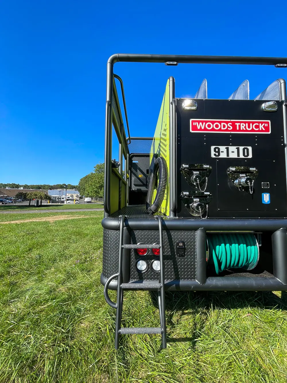 Full rear view with hose reel opening and ladder.