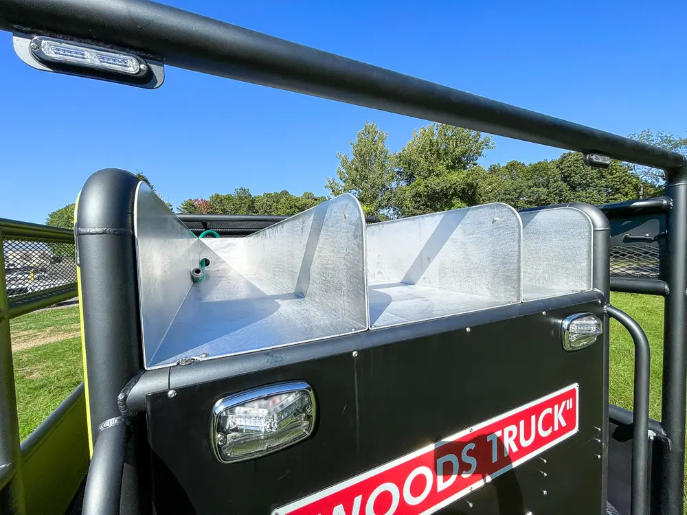 Open top trough or tank channel along rear deck side.