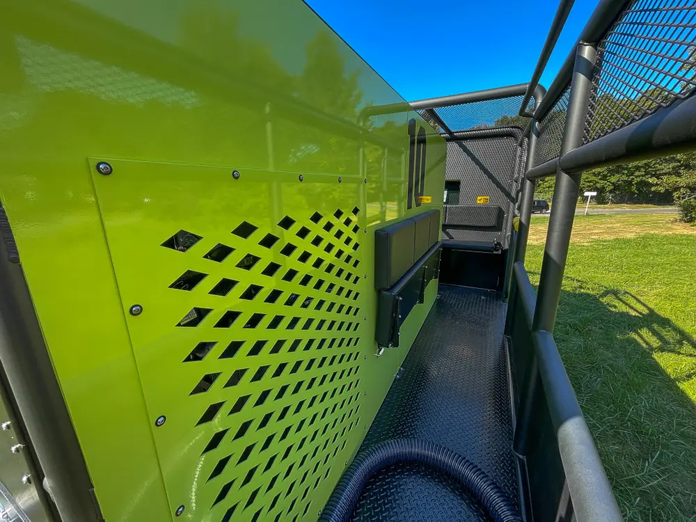 Perforated side body panel and walkway leading forward.