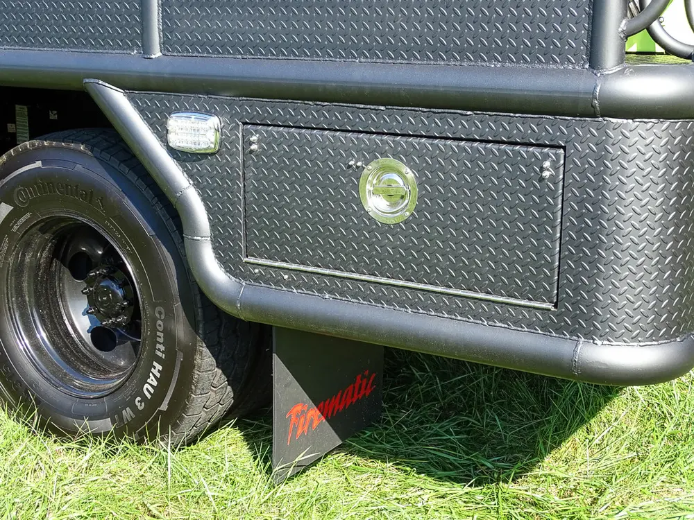 Rear wheel area and side compartment panel near mudflap.