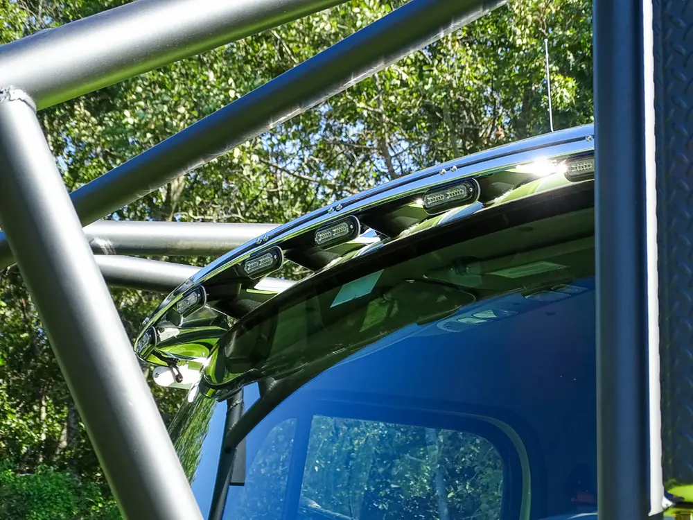 Cage crossbars above windshield from side angle.