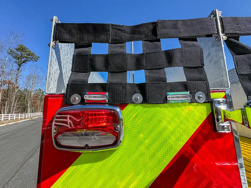 Rear chevron panel close-up with black cargo net and taillight.