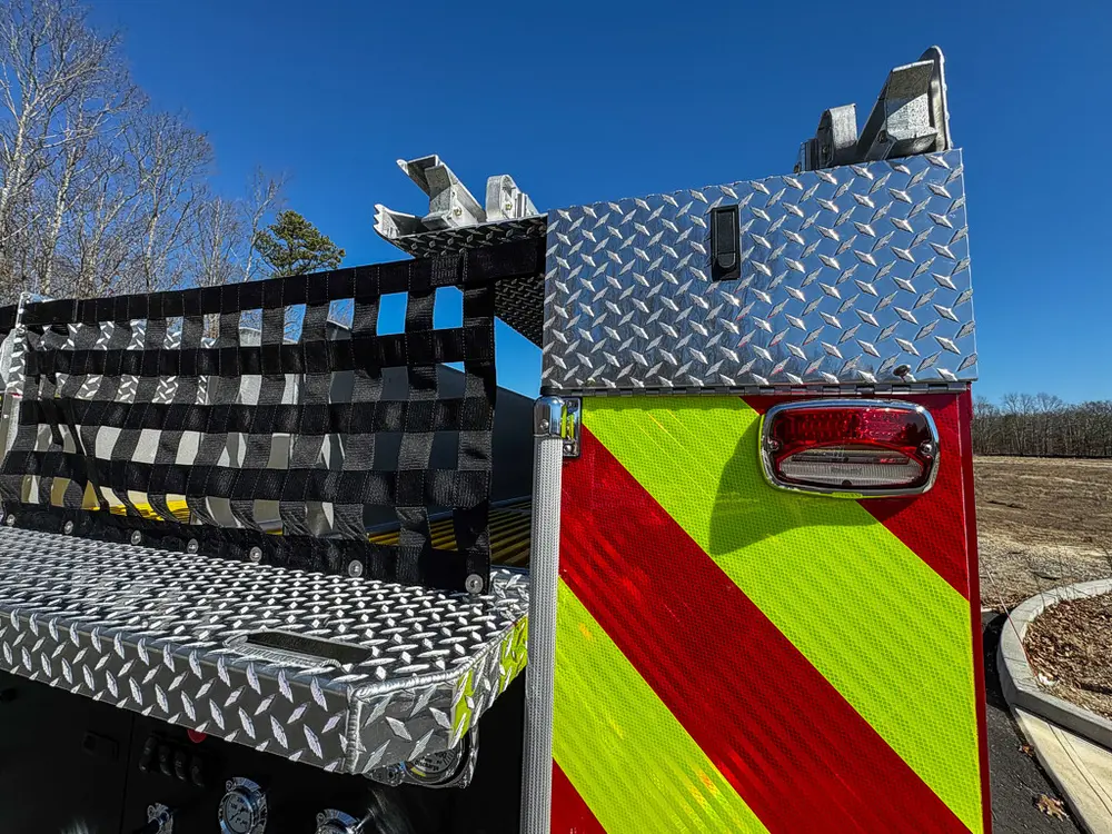 Rear upper corner with mounted cargo net and side light visible.