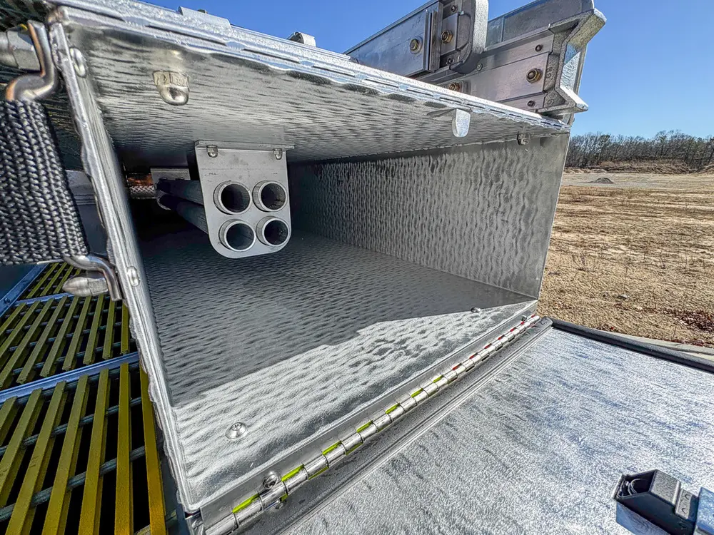 Open upper rear compartment with empty shelf and mounting points.