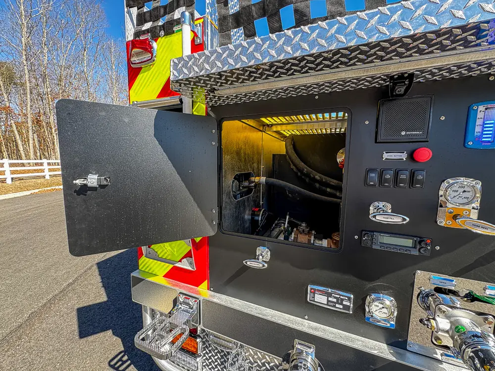 Pump panel with access door open revealing interior control cavity.