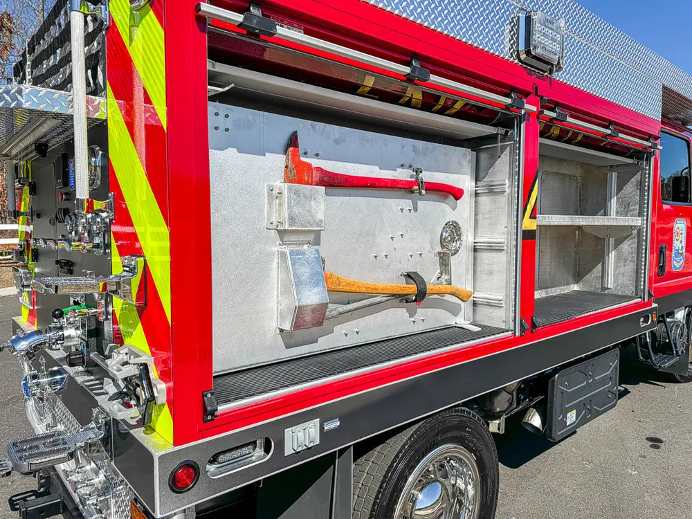 Open side compartment with tools mounted on the door panel.