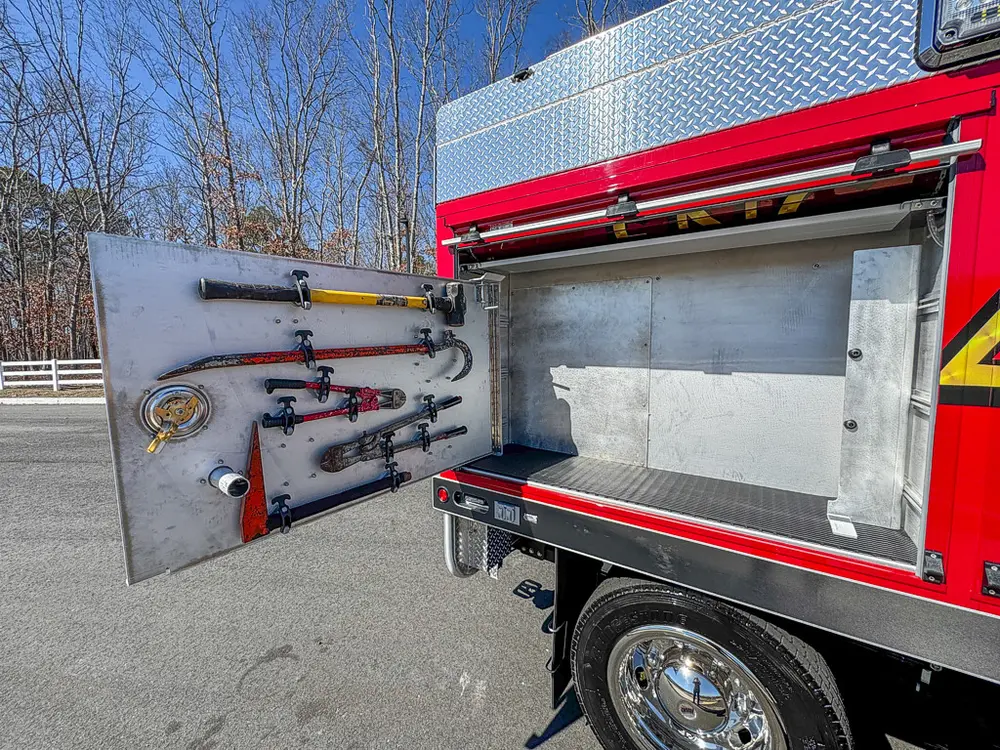 Open side compartment with tool mounts and shelf space.